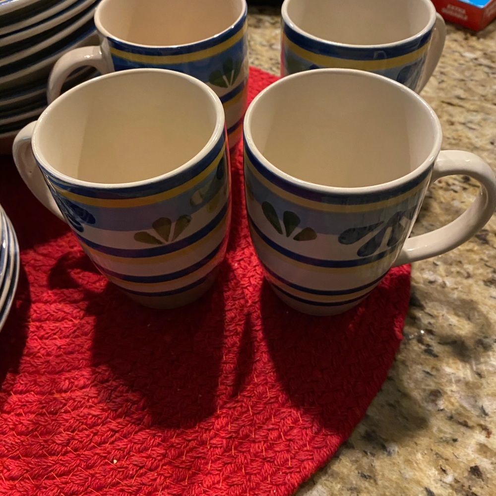 Partial dinner ware set saucers,mugs and bowls.